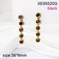 Detail of gold stainless steel long drop earrings with five black stone charms. - Black