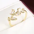 Elegant close-up of a golden branch and leaf ring with sparkling cubic zirconia stones - Size 6 / Gold + White (50838) / Gold+White