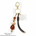 Vintage Western style beaded bag charm with woven leather tassel and matte flower pendant - Vintage Floral Bead Design