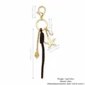 Western style starfish and woven rope bag charm in gold-finished alloy with pearl detail - Marine Starfish Shell Design