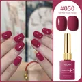 Deep cherry red gel nail polish bottle #050 shown with matching shiny manicured nails. - Cherry Red (#050)
