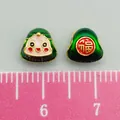 Cute set of two green enamel Zongzi baby charms with smiley face and Fu character - Small Green Straight Hole Smiley Zongzi (22642)