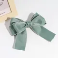 Vintage style sage green silk bow hairclip featuring delicate silver contrast threaded edges - Green