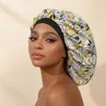 Close-up of a floral printed satin sleep bonnet on a model for hair care and protection - Adjustable / Yellow White Leaf Print