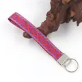 Detail view of an ethnic embroidered wristlet keychain featuring vibrant geometric patterns. - 07#