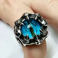 Close-up of a gothic stainless steel dragon eye ring with intricate skull claw details. - Vertical Eyes Sea Blue / Size 7