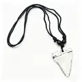 Close-up view of a white faux shark tooth resin necklace with vintage distressed details - White