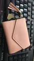 Elegant small pink women's wallet featuring a leather tassel and gold heart charm - Pink