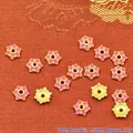 Macro view of pink enamel flower bead spacers with golden trim on textured background - 7mm / Rose Pink (P133)