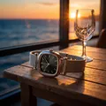 Elegant square women's watch with mesh band displayed in a beautiful sunset seaside setting - Black Dial