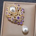 Detail shot of a luxury French vintage violet teardrop pearl brooch with crystal accents - Water Drop / Purple