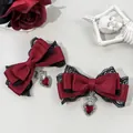 Close-up detail of gothic wine red bow hair clips with black lace and red heart pendants. - Burgundy (single)