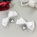 Detailed macro view of white lace bow hair clips with gothic heart and cross charms. - White (Single)
