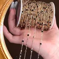 Detailed view of 4mm gold copper chain with black glass beads for DIY jewelry crafts - Black