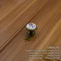 Close-up detail of European style floral ceramic drawer knob with antique bronze base - Oval Knob (1800A-01) / Length 74mm