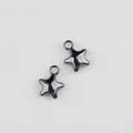 Detailed close-up of two gunmetal solid star pendants for DIY jewelry and earring making - Gunmetal Black - Medium 15*12mm