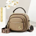 Stylish khaki round crossbody bag for women with wide woven strap and decorative gold K logo - Khaki
