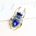 Vintage style beetle brooch crafted in gold-plated alloy with sparkling blue crystals - Sapphire Blue
