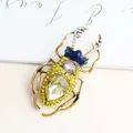 Elegant vintage beetle brooch featuring yellow rhinestones and deep blue enamel finish - Yellow