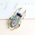 Exquisite vintage stag beetle brooch featuring pink and blue crystals with a golden alloy finish - Lake Blue