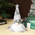 Detail of a gray knitted Christmas gnome doll with a glowing star and white beard - Gray