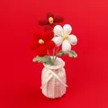 Hand-crocheted daisy flower arrangement in a white knit vase on red background - Gradient Red Frangipani (Yarn Vase)