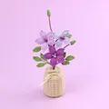 Handmade purple crochet flowers in a beige woven pot with an elegant white bow - Gradient Purple Clematis (Beige Vase)