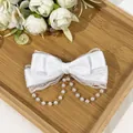 Detailed view of cream Lolita bow hair clip with delicate lace and pearl tassels - White