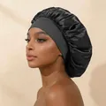 Black satin hair bonnet with wide elastic band worn by a model for hair protection - Black