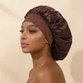 Side profile of a model wearing a large brown elastic wide-brimmed satin hair bonnet - Coffee
