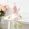 Close-up view of long-legged Easter gnome with pink bunny ears sitting on a white table - Lotus root pink