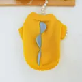 Detailed view of soft yellow knitted pet sweater featuring blue dinosaur fin decorations - Dinosaur Sweater - Yellow