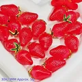 Detailed macro view of red strawberry crystal pendants with gold trim for DIY jewelry - Resin Strawberry Pendant (S409)