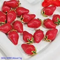 Detailed view of red strawberry pendants with gold leaf accents for DIY jewelry making - Resin Strawberry Pendant (S413)