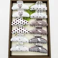 Variety of patterned hair claw clips with polka dots and hearts in a display tray. - Mixed Arc Patterns (12 Pieces)