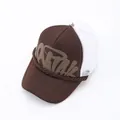 Close-up of brown trucker hat with white mesh and graffiti-style print detail. - Brown / Adjustable