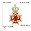Detail view of an ornate crown brooch with red enamel and rhinestones on gold alloy - Kc Gold-red White Diamond 4710-rd