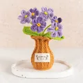 Handmade purple crochet flowers in a brown woven vase for cozy desktop decoration - Gradient Purple Forget-me-not