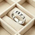 Detailed macro view of silver stainless steel ring with black Nordic Rune engravings - 4.5mm Wide Viking Characters