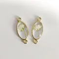 Handmade oval gold jewelry charms featuring real dried white flowers in clear resin - White Oval