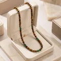 Bohemian men's necklace with coconut shell, wood beads, and green stone accents. - ZJ16356