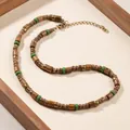 Bohemian handcrafted necklace with coconut shell, wood beads, and green stone accents - ZJ16360