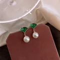 French vintage green leaf pearl earrings with silver needles on a velvet display - 69# Ginkgo Leaf Pearl Earrings