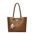 Large brown minimalist commuter tote bag featuring a gold kangaroo logo and plush charm - Brown