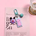 Close-up detail of a cute resin keychain featuring a purple monster and a milk tea tag - Milk Tea