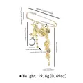 Gold-tone decorative brooch pin with moon and leaf charms, includes size and weight info - X0402 Round Plate