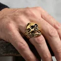 Close-up of golden stainless steel skull ring with intricate pirate-style detailing - US 7 / Gold Oiled