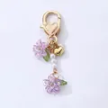Sweet purple flower variant keychain with a gold heart clasp and white pearls decoration. - Purple Lily Heart (Double Petals)