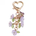 Sweet heart-shaped golden keychain featuring purple floral charms and an enamel butterfly charm - Double Flower Purple (Double Petals)