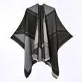 Detailed view of gray and black reversible poncho with geometric patterns and fringe - Large V-neck Short Beard Shawl Black And Gray / 130x150cm